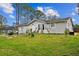 Charming single-story home with a well-manicured lawn, mature trees, and welcoming curb appeal at 2486 Daytona Park Rd, Deland, FL 32724