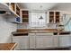 Kitchen featuring rustic open cabinets, durable counter tops, and an ornate hanging lamp at 2486 Daytona Park Rd, Deland, FL 32724