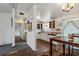 Bright kitchen with open cabinets and rustic flooring flowing to dining area at 2486 Daytona Park Rd, Deland, FL 32724
