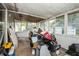 Enclosed screen room showing windows, ceiling and the room is full of various objects at 2486 Daytona Park Rd, Deland, FL 32724