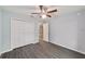 Neutral bedroom with a ceiling fan, light gray walls and wide plank wood-look flooring at 15673 Sw 37 Cir, Ocala, FL 34482