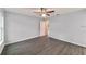 A bedroom with light gray walls and wide plank wood-look flooring at 15673 Sw 37 Cir, Ocala, FL 34482