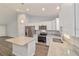 Well-equipped kitchen with a center island, stainless steel appliances, and sleek granite countertops at 15673 Sw 37 Cir, Ocala, FL 34482