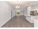 Spacious living room featuring modern flooring, a dining area, and abundant natural light at 15673 Sw 37 Cir, Ocala, FL 34482