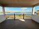 Spacious covered balcony with scenic views of the lake and surrounding landscape, offering a tranquil outdoor space at 16832 Bolsena Dr, Bella Collina, FL 34756