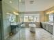 Bright bathroom features a standalone tub, double vanity, and lots of windows at 16832 Bolsena Dr, Bella Collina, FL 34756