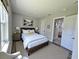 Cozy bedroom with a queen-sized bed, bedside tables, lamps, and an ensuite bathroom at 16832 Bolsena Dr, Bella Collina, FL 34756