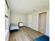 Bedroom featuring hardwood floors, a window, and an ensuite bathroom at 16832 Bolsena Dr, Bella Collina, FL 34756