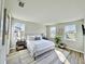 Bedroom featuring a queen bed, neutral colors, and lots of natural light from the multiple windows at 16832 Bolsena Dr, Bella Collina, FL 34756