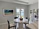 Cozy dining area with a charming table, elegant decor, and picturesque views of the serene lake at 16832 Bolsena Dr, Bella Collina, FL 34756