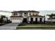 Beautiful two-story home with a two-car garage, landscaped front yard, and a well-maintained lawn at 16832 Bolsena Dr, Bella Collina, FL 34756