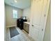 Efficient laundry room with modern washer and dryer, a sink with storage, and stylish patterned floors at 16832 Bolsena Dr, Bella Collina, FL 34756