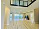 Bright living room boasting hardwood floors, expansive windows, and breathtaking lake views at 16832 Bolsena Dr, Bella Collina, FL 34756