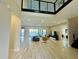 Bright living room featuring tile floors, contemporary furniture, and sliding glass doors leading to a beautiful lake view at 16832 Bolsena Dr, Bella Collina, FL 34756