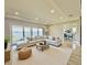 Bright living room with plush seating, recessed lighting, and sliding glass doors offering scenic lake views at 16832 Bolsena Dr, Bella Collina, FL 34756