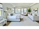 Spacious main bedroom featuring a large bed, bright windows, and a comfortable sitting area at 16832 Bolsena Dr, Bella Collina, FL 34756