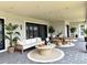 Relaxing outdoor patio with comfortable seating, stylish decor, and a peaceful ambiance perfect for entertaining at 16832 Bolsena Dr, Bella Collina, FL 34756