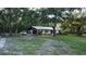 Charming single-story home with a well-manicured lawn and mature trees providing ample shade at 11990 Se 112Th Avenue Rd, Belleview, FL 34420