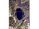 Aerial view of the lot with a private pond, set amid surrounding trees, perfect for a secluded retreat at 11990 Se 112Th Avenue Rd, Belleview, FL 34420