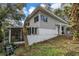 Side view of home exterior showing screened porch, yard, and architectural details at 1630 Lakeview Ct, Eustis, FL 32726