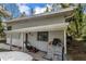 View of home exterior showing front porch, lawnmower, driveway, and white car parked at 1630 Lakeview Ct, Eustis, FL 32726