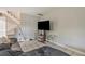View of living room features staircase, tile floors, TV, and couch at 1630 Lakeview Ct, Eustis, FL 32726