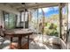 Enclosed patio featuring a table and view of the landscaped yard at 1630 Lakeview Ct, Eustis, FL 32726