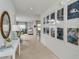 Inviting hallway with modern decor, light tile flooring, and views of the living areas at 2034 Babbling Brook Blvd, Auburndale, FL 33823