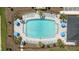 Aerial view of a large pool with lounge chairs and umbrellas, surrounded by landscaping at 2034 Babbling Brook Blvd, Auburndale, FL 33823
