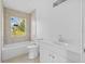 Bright bathroom features a shower-tub combo, vanity with sink, and large window at 1132 Avenue K # A, Haines City, FL 33844