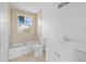 Bright bathroom featuring a bathtub, tiled walls, and a modern white vanity with a sink at 1132 Avenue K # A, Haines City, FL 33844