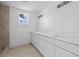 Bright bathroom showcasing a long vanity with double sinks, white cabinets, and modern fixtures at 1132 Avenue K # A, Haines City, FL 33844