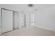 Neutral bedroom with light wood floors, closet, and open doorway at 1132 Avenue K # A, Haines City, FL 33844