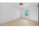 Bright, minimalist bedroom with light wood flooring and a large window at 1132 Avenue K # A, Haines City, FL 33844