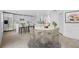 Bright dining area with modern table, chairs, and an open layout connected to a kitchen with white cabinetry at 1132 Avenue K # A, Haines City, FL 33844