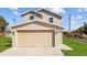 Close up of a two-car garage with a concrete driveway at 1132 Avenue K # A, Haines City, FL 33844