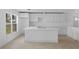 Bright kitchen features white cabinets, a center island, and modern countertops at 1132 Avenue K # A, Haines City, FL 33844