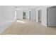 Spacious living area with light tile flooring, white walls, and multiple entryways at 1132 Avenue K # A, Haines City, FL 33844