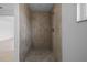 Tiled shower stall with modern fixtures and a patterned floor at 1132 Avenue K # A, Haines City, FL 33844