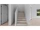 Wooden staircase connecting two levels of the home; doors on both floors at 1132 Avenue K # A, Haines City, FL 33844