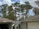 Arched gate to fenced side-yard near a one car garage and a two car garage at 1818 Lago Ct, St Cloud, FL 34769