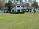 Charming two-story home with a well-manicured lawn and lush landscaping at 1818 Lago Ct, St Cloud, FL 34769