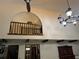 Open-concept with chandelier and view to second story landing at 1818 Lago Ct, St Cloud, FL 34769