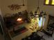 Inviting living room with cozy fireplace and Christmas tree at 1818 Lago Ct, St Cloud, FL 34769