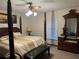 Comfortable main bedroom with a four-poster bed and classic furnishings at 1818 Lago Ct, St Cloud, FL 34769