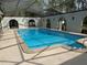Inviting indoor pool area featuring a large, sparkling pool and elegant architectural details at 1818 Lago Ct, St Cloud, FL 34769