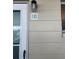 Close up of a condominium entrance showing the door, unit number, and surrounding wall at 335 N Causeway # E3, New Smyrna Beach, FL 32169