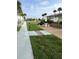 Landscaped common grounds with picnic area, barbecue grill, and charming walkway at 335 N Causeway # E3, New Smyrna Beach, FL 32169