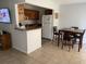 Bright kitchen and dining area with tiled floor, wood cabinets, and modern appliances at 335 N Causeway # E3, New Smyrna Beach, FL 32169