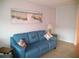 Cozy living room with comfortable sofa, beach-themed decor, and tiled flooring at 335 N Causeway # E3, New Smyrna Beach, FL 32169